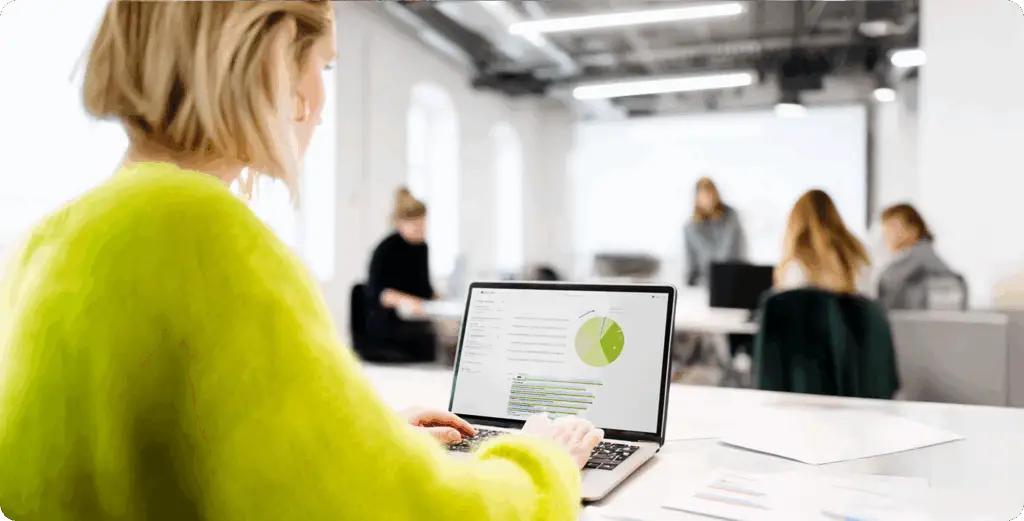 Digital advisory assessment and data analysis on a laptop in a corporate office.