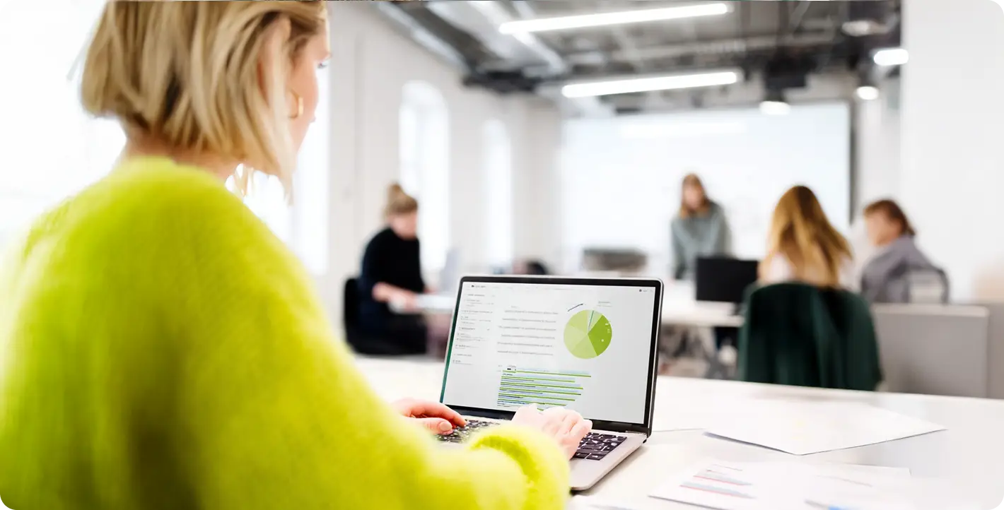 Digital advisory assessment and data analysis on a laptop in a corporate office.