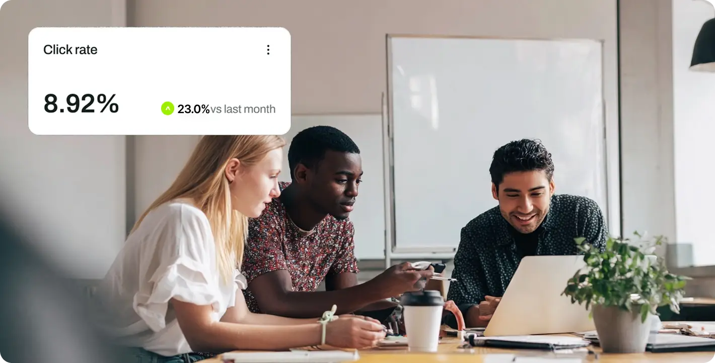 Marketing team collaborating around a laptop with a digital data overlay showing increased click rate metrics.