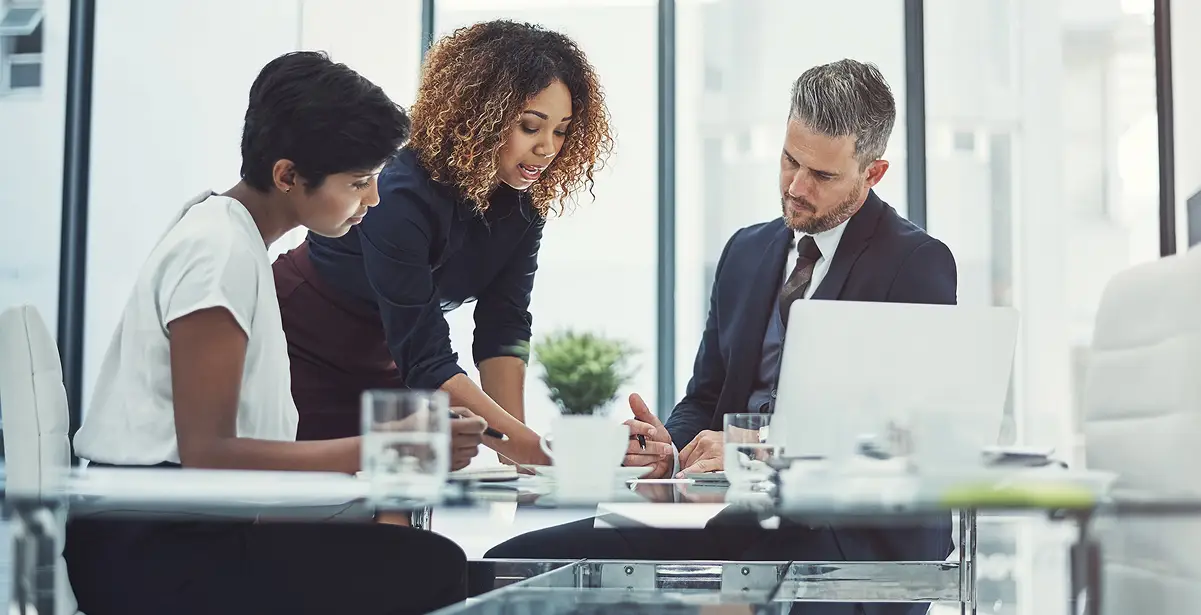 A diverse group of business professionals collaborating in a modern corporate office.